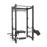 The Manticore Four Post Power Rack Builder by Bells of Steel features a black 3" x 3" steel frame with modular components, adjustable safety bars, pull-up bar, padded bench, peg holes for customization, brand logo on top, and weight storage pegs on both sides.