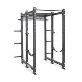 The Bells of Steel Manticore Six Post Power Rack Builder features 3x3 uprights, a pull-up bar, adjustable safety straps, multiple holes for modular components, and side weight storage pegs.