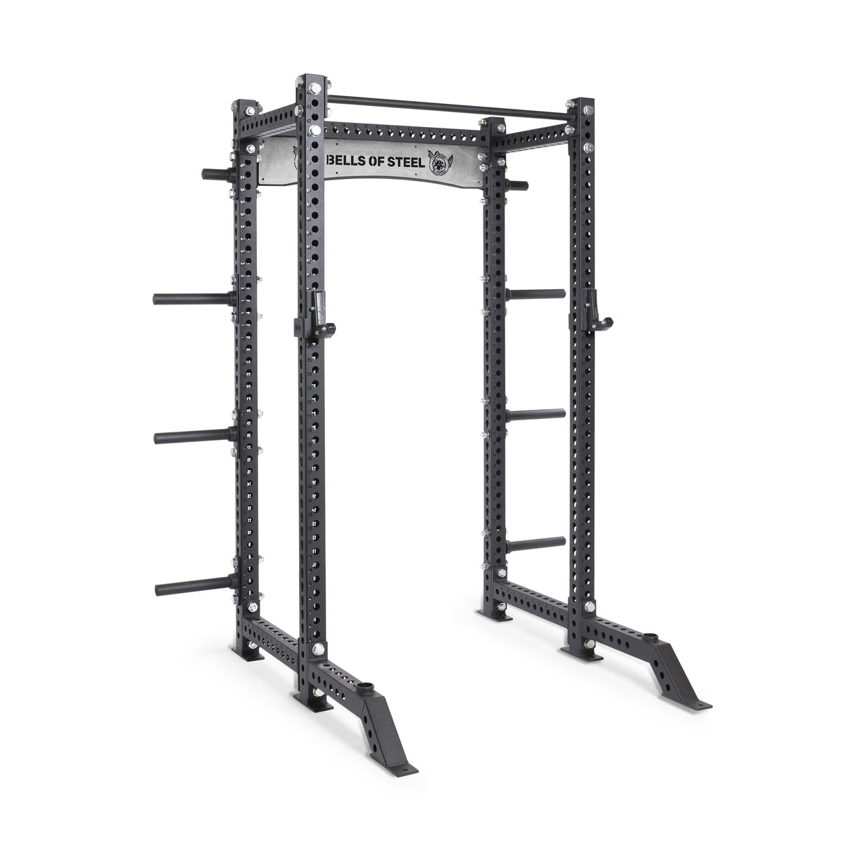 The Bells of Steel Manticore Collegiate Power Rack Builder has a 1,000-pound capacity with adjustable barbell placements via 1" holes. It features side storage pegs for weight plates, a top pull-up bar, and displays the brand name on the upper panel.