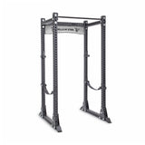 The Bells of Steel Manticore Flat Foot Power Rack - Prebuilt (3" x 3", 1" Holes) is a sturdy gray weightlifting rack with multiple adjustment holes and a top pull-up bar, perfect for any home gym setup.