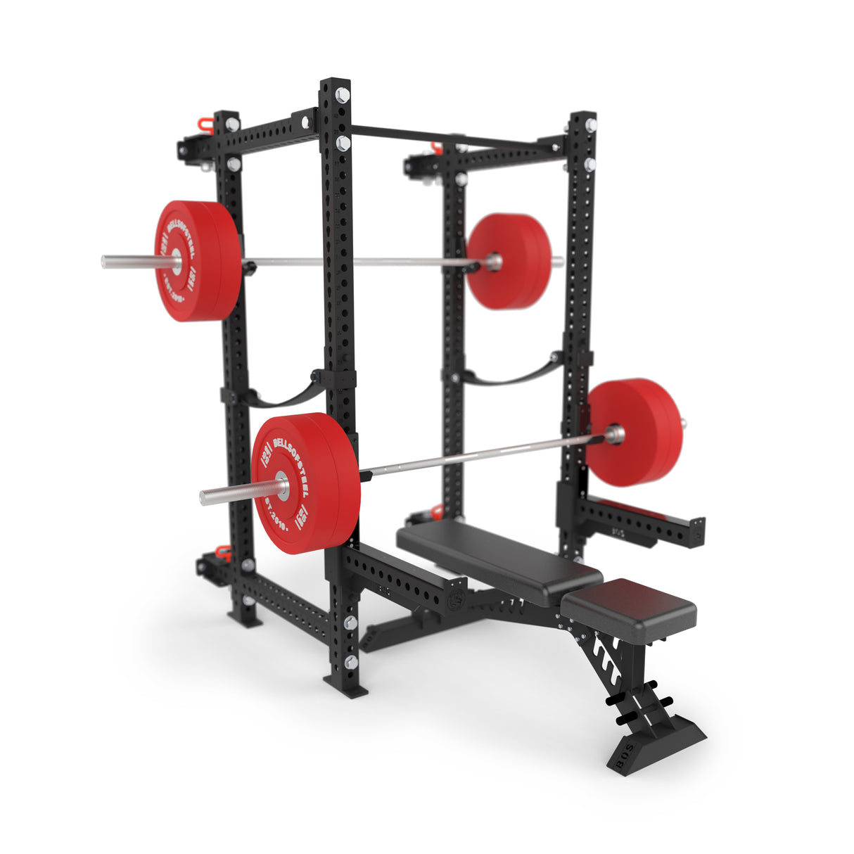 The Bells of Steel Manticore Folding Power Rack Builder, in black with 3" x 3" uprights and 1" holes, sits next to a bench press. It features red weight plates, adjustable safety bars, multiple bar placement options, and supports up to 1,000 pounds.