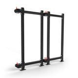 The Bells of Steel Manticore Folding Power Rack Builder features a robust metal frame with perforated black beams and red caps. Its flat base supports 1,000 pounds with horizontal supports connecting two vertical uprights, ideal for industrial or gym use.