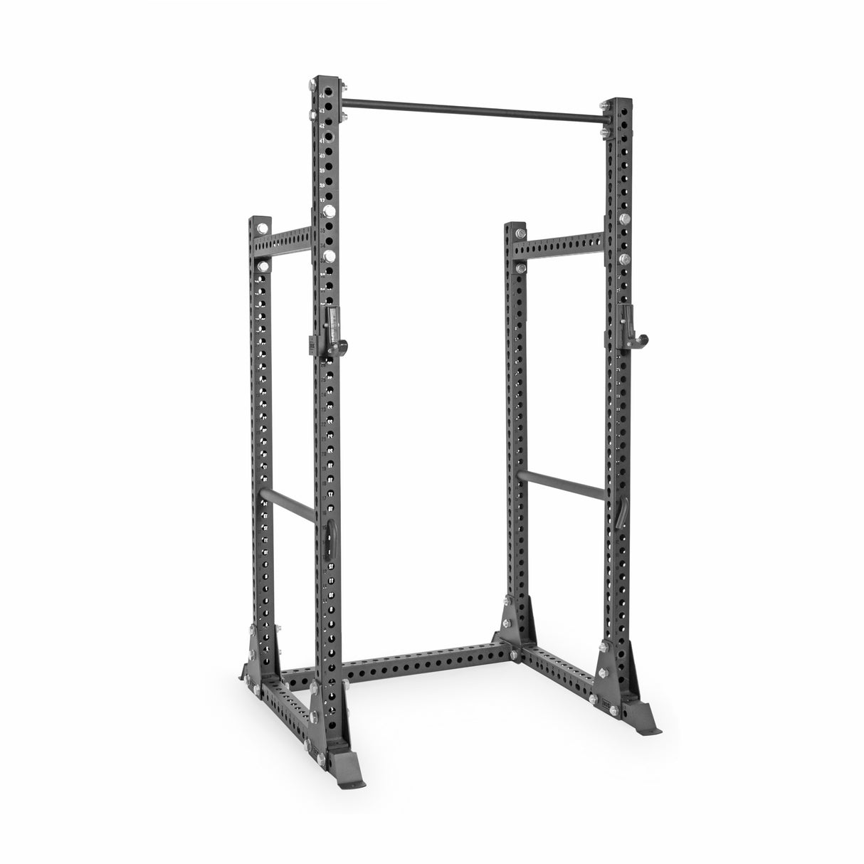 The Manticore Half Rack Builder, from Bells of Steel, is a sturdy black metal rack (3" x 3", 1" holes) with a pull-up bar. It features adjustable heights and stands on a flat base, ideal for weightlifting and strength training exercises with modular components.