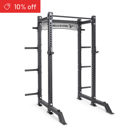 The Bells of Steel Manticore Collegiate Power Rack Builder features 3"x3" uprights, 1" holes for adjustable supports, side plate storage pegs, and a top "BELLS OF STEEL" label. A red "10% off" tag highlights this ideal home gym upgrade.