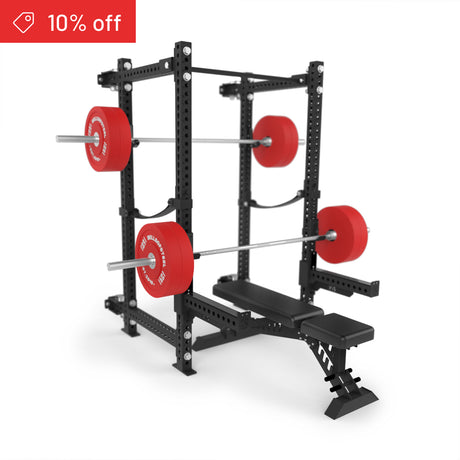 The Bells of Steel Manticore Folding Power Rack Builder (3" x 3", 1" holes) is shown with a bench and barbells with red plates on a white background, featuring a red "10% off" tag—ideal for your home gym.