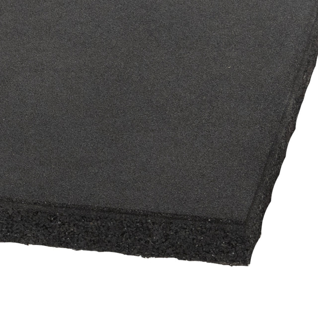 A close-up of a Bells of Steel Deadlift Platform Rubber Tile shows its black, rectangular shape with a textured surface and smooth edges, designed for floor protection as part of a modular platform, against a white background.