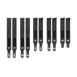 Nine Bells of Steel Mighty Wrist Wraps, made of black nylon with Velcro fasteners and branded labels, are lined up on a white background. These wraps offer wrist support and style—perfect for powerlifting essentials.