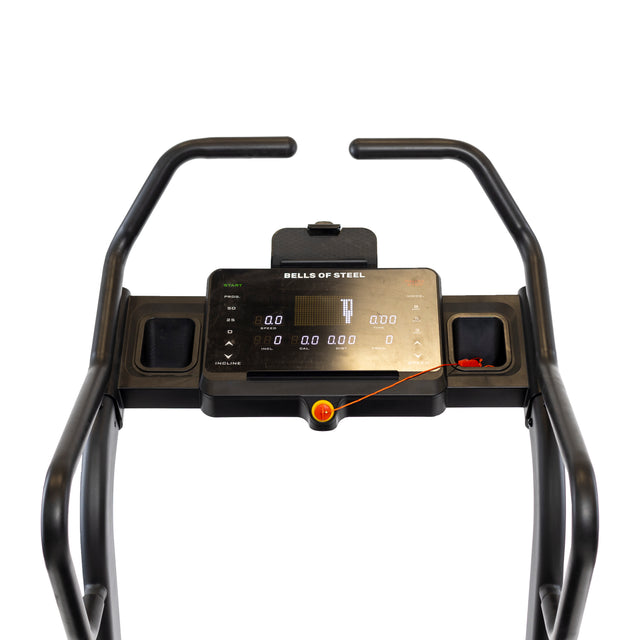 Close-up of the Blitz Mountain Climber Treadmill console with handlebars. The display shows "Bells of Steel" and various readings with zeros. A safety key with a red cord is attached below the screen, highlighting its role as a cardio machine.