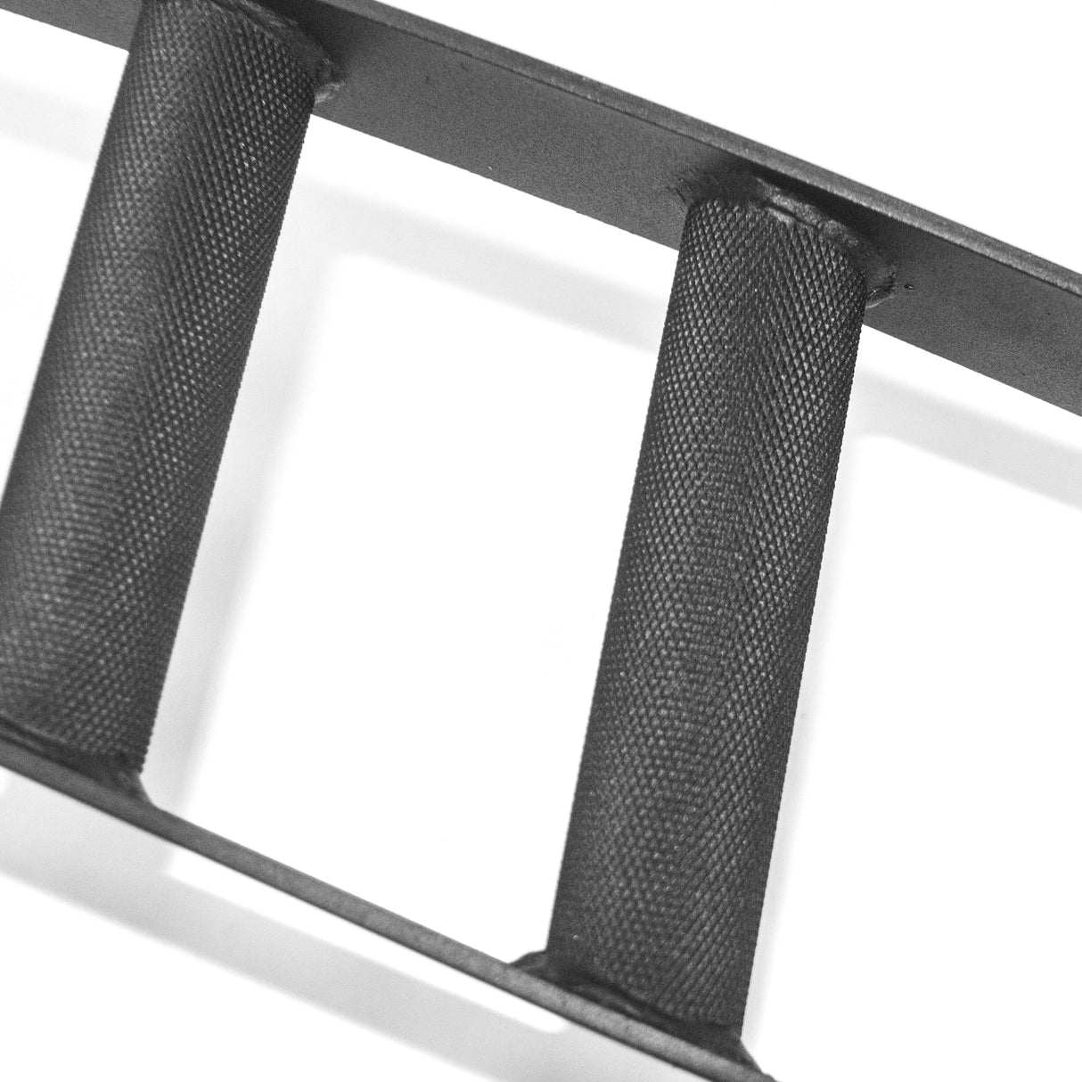 Close-up of three knurled, textured black handles from the Bells of Steel Omni Bar, showcased horizontally against a plain white background.