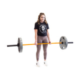 Female athlete holding Multi-Purpose Olympic Barbell – The Utility Bar - Orange Cerakote