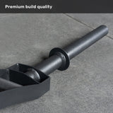 A close-up of the Bells of Steel Arch Nemesis Swiss Bar, a black specialty barbell, rests on a gray stone floor with "Premium build quality" displayed at the top left corner.