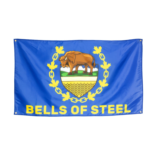 The Bells of Steel flag is blue with a bison on a crest, detailed with wheat and green grass. A yellow wreath of maple leaves adds charm, while "BELLS OF STEEL" is displayed prominently below, making it an ideal decor piece for your home gym.