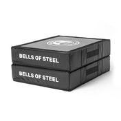 Two black, rectangular Bells of Steel Deadlift Pads are stacked to highlight their durability. Featuring convenient handles for easy transport, these silencer pads effectively minimize noise during intense workouts.