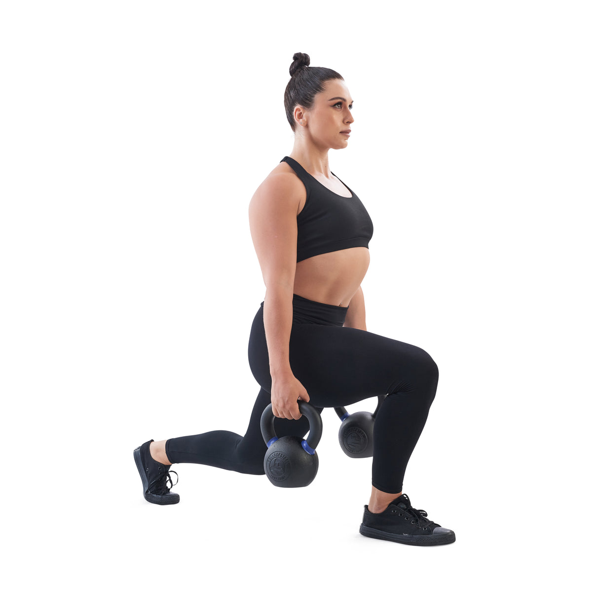 Female athlete doing a lunge with Powder Coated Kettlebells