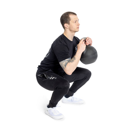 male model performing squat with the Adjustable Kettlebell