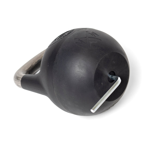 A plastic-bottom adjustable kettlebell by Bells of Steel lies horizontally, with a metallic handle and an Allen wrench in a side hole for weight increments. Its smooth black surface is marked, making it suitable for single-arm exercises.