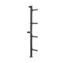 The Bells of Steel Wall-Mounted Plate Storage Rack is a black, vertical rack with four horizontal pegs, designed to optimize home gym storage by securely mounting weight plates on the wall.