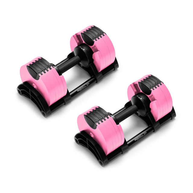 The NÜOBELL Adjustable Dumbbells from Nuobell feature pink and black accents with knurled handles for a secure grip, machined steel weight plates on each end, and are presented on a sleek black base.