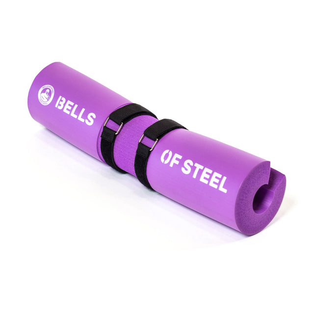 The ergonomic Barbell Pads with Straps by Bells of Steel come in purple and have two black adjustable straps, designed to offer optimal cushioning for weightlifting.