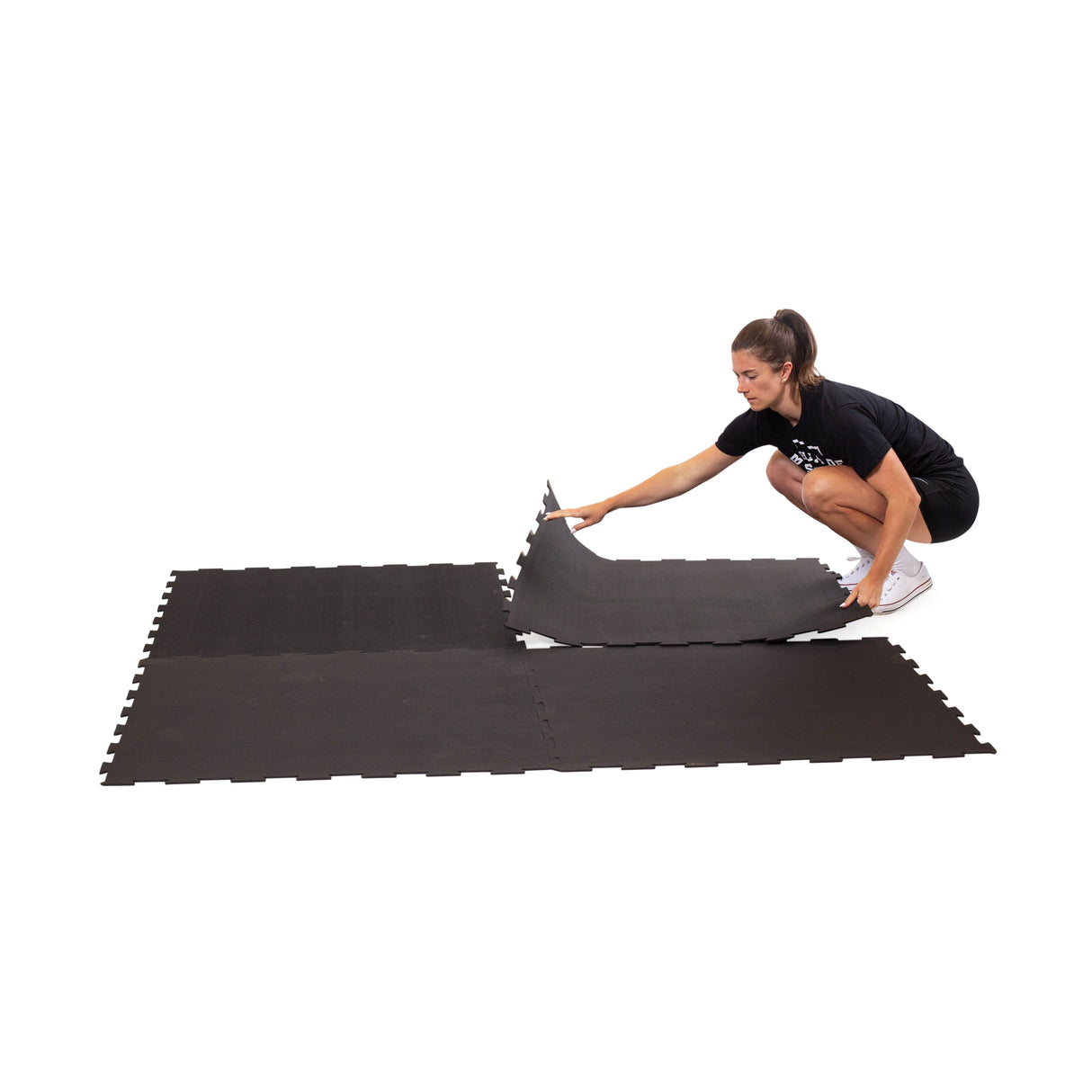 Set of black puzzle mats forming a cushioned exercise area.