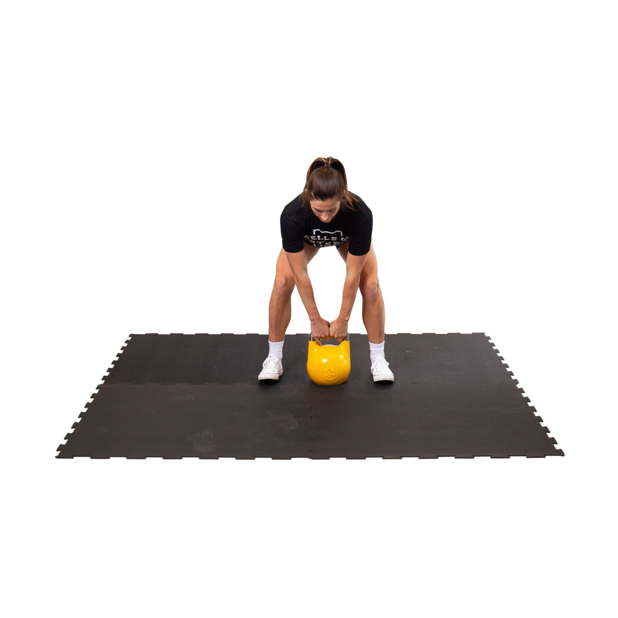 female athlete using the Black Puzzle Mat for ketllebell workouts