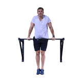 Male athlete doing muscle-ups on an adjustable wall or ceiling mounted pull-up bar.