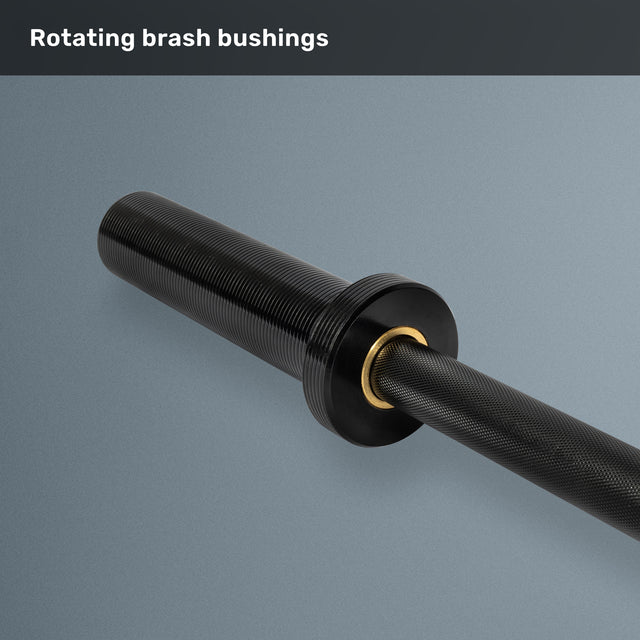 A close-up of the Bells of Steel Short Rackable Barbell sleeve with rotating brass bushings, textured grip, and smooth metallic finish—ideal for home gyms. Text at the top reads, "Rotating brass bushings.