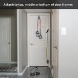 Human Trainer - Ripcords from Bells of Steel USA, featuring rubber handles, are secured to the top, middle, or bottom of a closed white door with a door anchor in a gray hallway. Text at the top reads: “Attach to top, middle or bottom of door frames.”.