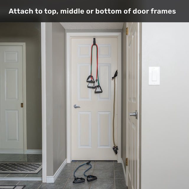 Human Trainer - Ripcords from Bells of Steel USA, featuring rubber handles, are secured to the top, middle, or bottom of a closed white door with a door anchor in a gray hallway. Text at the top reads: “Attach to top, middle or bottom of door frames.”.