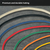 Six colored Human Trainer - Ripcords by Bells of Steel USA (white, black, blue, green, orange, and yellow) are arranged in parallel curves on a gray surface. At the top, the text reads “Premium and durable tubing.” This versatile set can be paired with rubber handles or a door anchor for resistance band workouts.