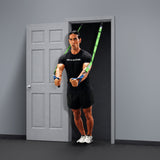 Wearing a black t-shirt and shorts, a person works out in a minimalist room, leaning forward and gripping the handles of green Human Trainer - Ceiling Mounts by Bells of Steel USA, which are securely fixed overhead for suspension training.