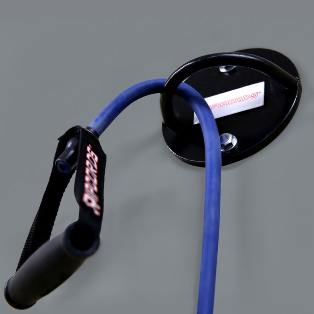 A close-up of a Human Trainer - Ceiling Mounts by Bells of Steel USA, featuring a blue resistance band with black handles attached to the ceiling-mounted anchor as part of a resistance band setup for fitness or physical therapy exercises, set against a plain gray background.