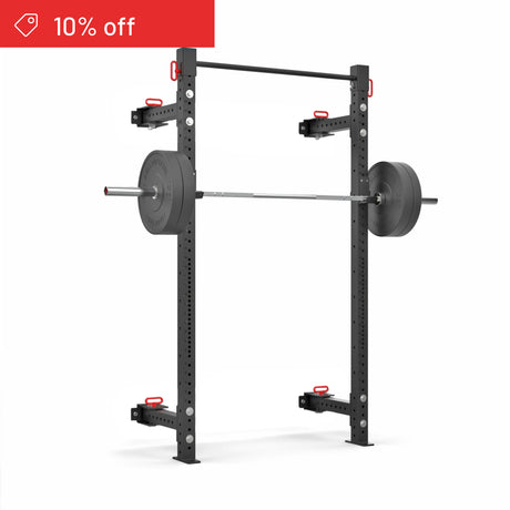 The Bells of Steel Roc Foldable 2 Post Cage Builder (3" x 3", ⅝" holes), shown in black with a loaded barbell and safety arms, is set against a white background. A red "10% off" banner appears in the top left. Ideal for home gyms.