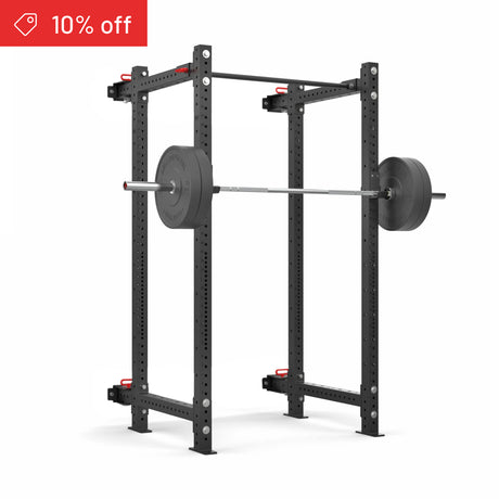 The Bells of Steel Roc Foldable 4 Post Cage Builder (3" x 3", ⅝" Holes) in black, set up with a loaded barbell for squats, is shown on a white background. A red “10% off” banner appears—ideal for your home gym.