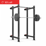 The Bells of Steel Roc Foldable 4 Post Cage Builder (3" x 3", ⅝" holes) with an Olympic barbell and weight plates is shown on a white background. A red "10% off" banner in the top left makes it ideal for any home gym.