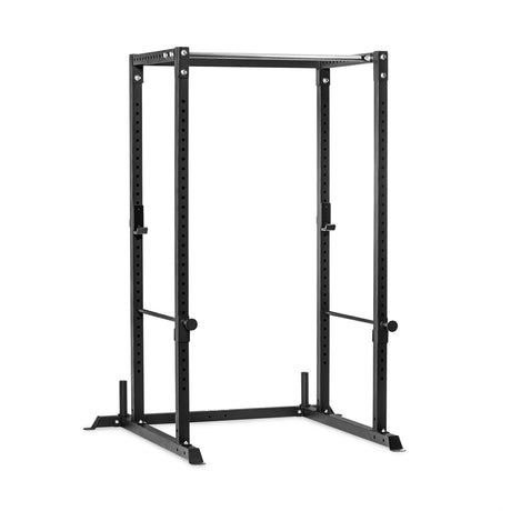 Bells of Steel Residential Power Rack in black steel with vertical uprights featuring hole spacing for adjustable J-cups and safety bars, ideal for a home gym.