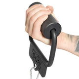 A tattooed forearm grips the Fat Bar - Single D Handle by Bells of Steel against a white background, demonstrating strong grip. The thick cylindrical bar is attached to a black metal D-shaped frame, with "POSEY" visible, adding character to the scene.