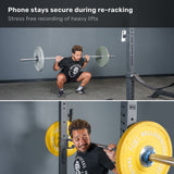 A man squats with a barbell in a gym, while his phone—secured nearby on the Bells of Steel USA Selfie Sentinel Magnetic Rack Phone Holder—records the session. The caption highlights how the Selfie Sentinel keeps his phone secure, even during re-racking.