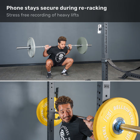 A man squats with a barbell in a gym, while his phone—secured nearby on the Bells of Steel USA Selfie Sentinel Magnetic Rack Phone Holder—records the session. The caption highlights how the Selfie Sentinel keeps his phone secure, even during re-racking.