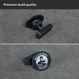 Two close-up views of the black knob on a gray surface highlight the “BELLS OF STEEL EST. 2010” stamp with a muscular figure logo and “Premium build quality” above—designed for perfect compatibility with the Bells of Steel USA Selfie Sentinel - Magnetic Rack Phone Holder, making it easy to capture hands-free workout videos or photos using your gym tripod.