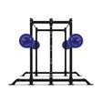 The Bells of Steel Hydra 2-Sided Rack is a sturdy black metal power rack with two blue barbells, featuring a rectangular frame and multiple adjustment holes—ideal for modular home gyms and strength training.