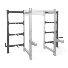 The Bells of Steel Hydra Batwing Storage is a black metal squat rack attachment with three horizontal bars, shown mounted on the left side of a transparent modular gym rack for versatile power rack storage.