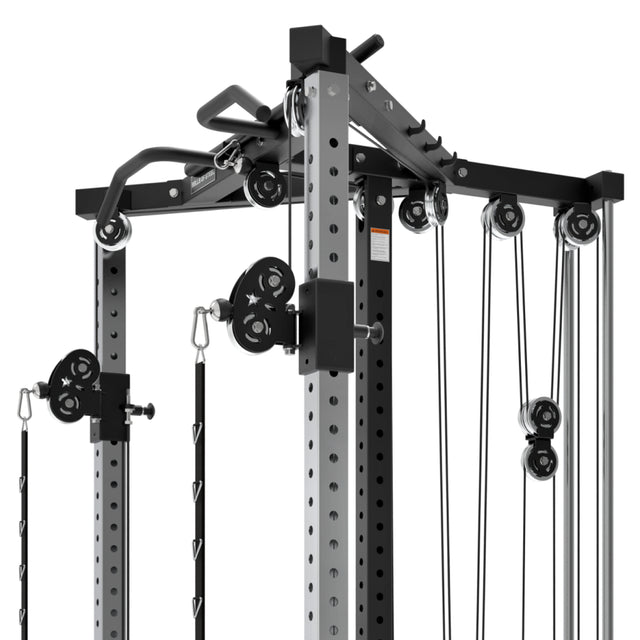 Close-up of a Bells of Steel All-in-One Trainer in a gym, showcasing pulleys, cables, and attachments for weight training. A robust metal frame makes it ideal for strength and resistance workouts.