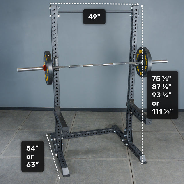 A Bells of Steel Manticore Squat Stand Builder (3" x 3", 1" Holes) in black, featuring 3x3 uprights and a barbell, with labeled dimensions: width of 49", height options of 75¼", 87¼", 93¼", or 111¼", and base height choices of either 54" or 63". Perfect for home gym setups, the squat stand is positioned on a gray tiled floor against a plain wall background.
