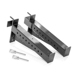 Displayed on a white background are two black metal adjustable Spotter Arms Rack Attachments with multiple holes and angled ends, plus two silver locking pins from Bells of Steel—ideal heavy-duty rack accessories for barbell safety.