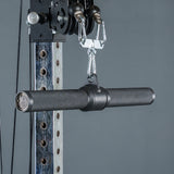 A close-up of the Bells of Steel Fat Bar - Straight Handle Bar, a black textured cable machine attachment, connected to a weight machine pulley system against a gray background.