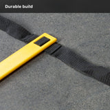 A yellow plastic bar attached to a black woven strap rests on a gray surface, with the caption “Durable build” displayed at the top. This piece is part of the Agility Ladder and Leg Cord Bundle from Bells of Steel USA, designed for agility training and to enhance any speed and agility kit.