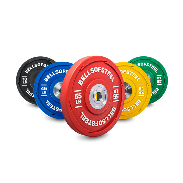 The Bells of Steel Urethane Bumper Plates are shown upright, ideal for Olympic weightlifting, with weights labeled: red (55 lb), blue (45 lb), green (35 lb), yellow (25 lb), and black (15 lb) against a white background.