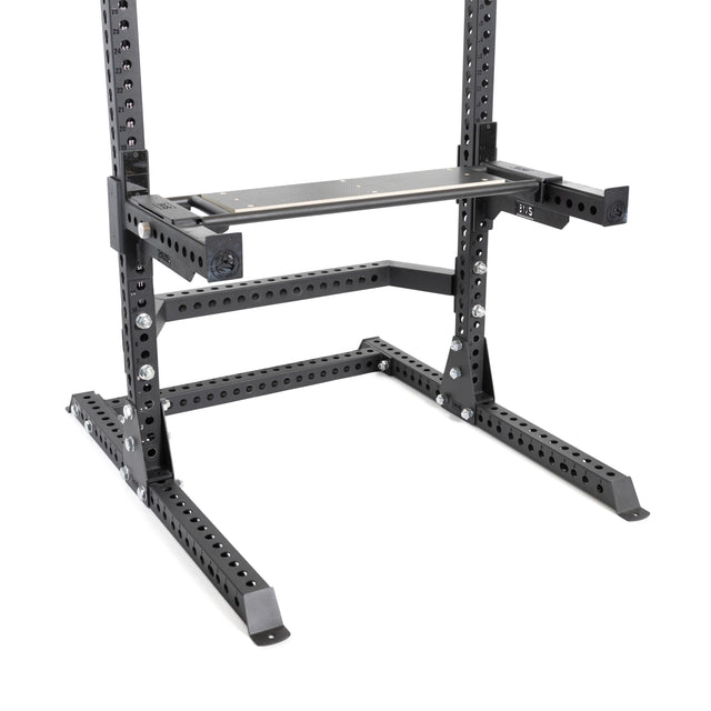A close-up of the Bells of Steel Utility Seat for Hydra/Manticore attached to a black 3"x3" rack frame with a flat bench, showing multiple holes for adjustable weightlifting and strength training settings.