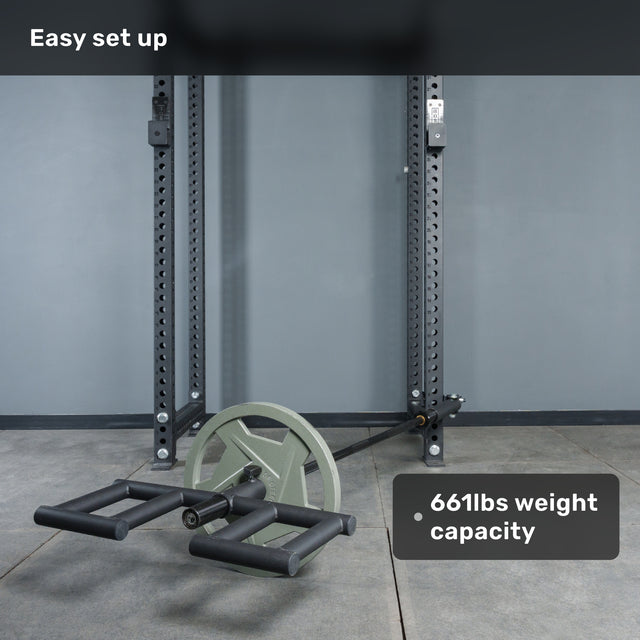 A Bells of Steel Viking Press Attachment with two large wheels is set up indoors near a power rack. Overlay text reads "Easy set up" and "661lbs weight capacity.